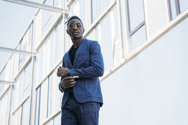 Portrait of fashionable businessman wearing blue suit and grey turtleneck  pullover stock photo