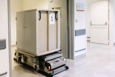Metallic container on robotic trolley moving in hospital - DGOF01288