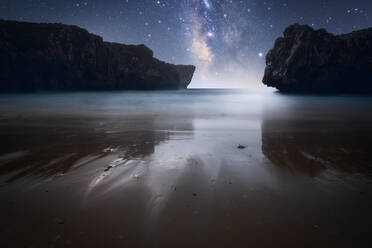 Amazing scenery of sea coast with calm water and rocky cliffs under dark sky with Milky Way - ADSF15052
