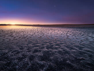 Beautiful colorful sunset sky over dried river with drought and damp shore - ADSF15067