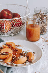 Schüssel mit gesundem Müsli, Joghurt und frischem Obst auf dem Tisch - ADSF15125