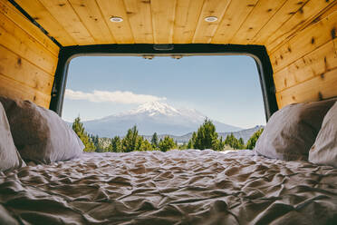 View of Mount Shasta from bed of camper van in Oregon. - CAVF88741