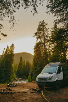 Camper van by riverbed during golden hour sunset near Aspen, Colorado. - CAVF88752