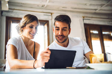 Young couple watching tablet at home - EHF00912