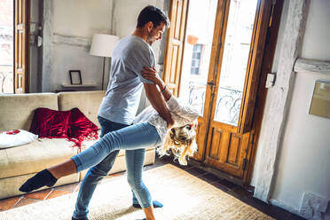 Young couple dancing in living room at home - EHF00952