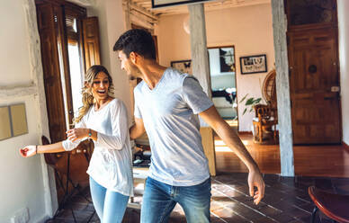 Young couple dancing in living room at home - EHF00958