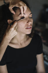 Make-up artist applying mascara on bride eye - ALBF01466