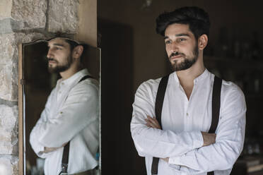 Groom standing with arms crossed at dressing room - ALBF01490