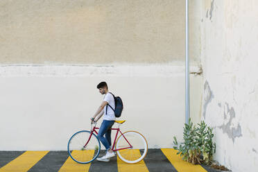 Side view of a man riding a fixie bike - ADSF15175