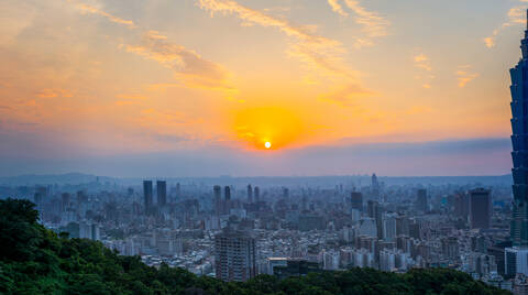 Magnificent panoramic view of sunset with colorful cloudy sky over modern city with skyscrapers in summer evening in Taiwan stock photo