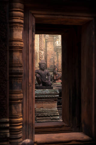 Historic stone statues in Banteay Srei Buddhist temple located in Cambodia stock photo