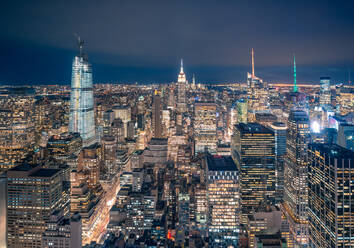 From above of night New York City with illuminated colorful skyscrapers against dark sky - ADSF15488