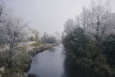 Amazing view of calm garden with river and trees covered with frost during winter in Burgos - ADSF15600