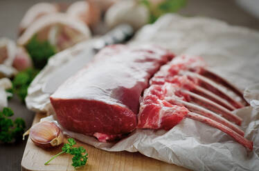 Fresh rack of raw lamb on cutting board - CAIF29485
