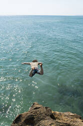 Man diving in sea on sunny day - AFVF07234