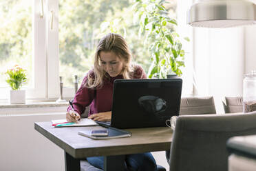 Female teenager studying at home - MASF19720