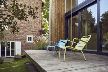 Empty chairs on hardwood floor outside tiny house - MCF01408