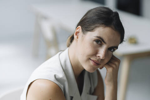 Beautiful woman sitting on chair at office stock photo