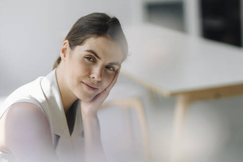 Thoughtful businesswoman sitting at office stock photo