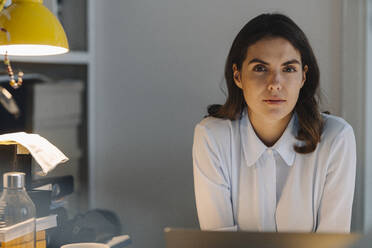 Woman working on laptop at home - KNSF08524