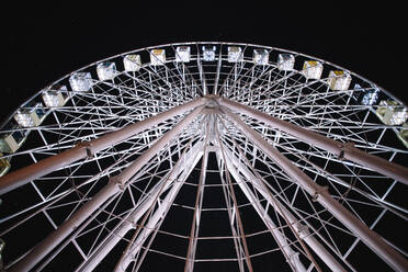 Illuminated Ferris wheel in city during night - CAVF88768