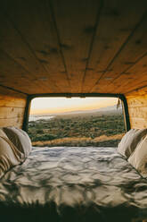 Sunset view of ocean from bed of a sprinter van Baja, Mexico. - CAVF88850