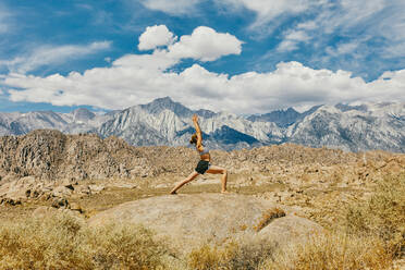 Young woman practicing yoga near Alabama Hills in northern California. - CAVF88872