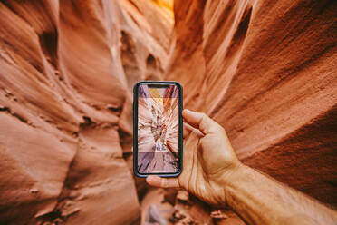 Taking picture with phone of narrow slot canyons in Escalante, Utah - CAVF88917