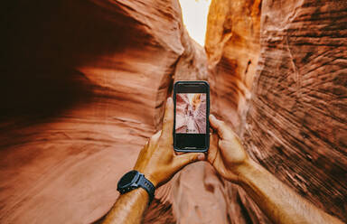 Taking picture with phone of narrow slot canyons in Escalante, Utah - CAVF88918