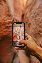 Taking picture with phone of narrow slot canyons in Escalante, Utah - CAVF88923