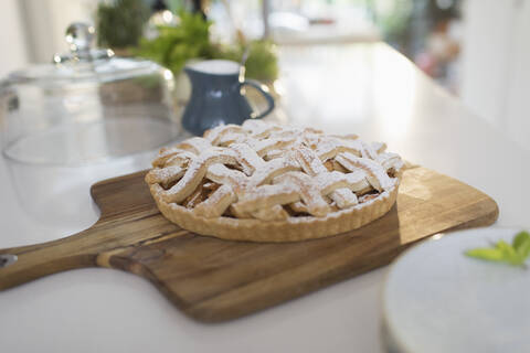 Fresh homemade baked lattice apple pie on cutting board stock photo