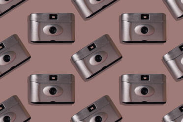 Close-up of retro cameras on pink background - ERRF04329