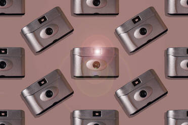 Retro cameras over pink background - ERRF04330