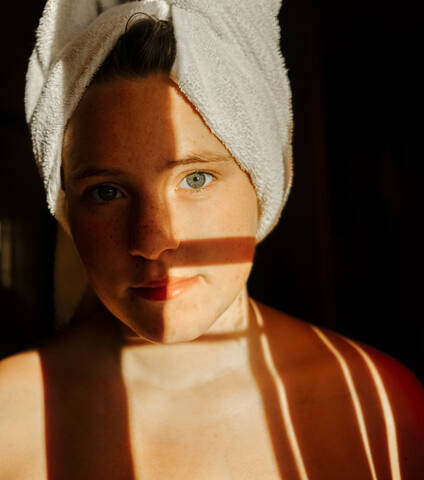 Close-up of girl wearing towel in bathroom stock photo