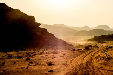 Sunset across sand dunes and mountains in the desert of Wadi Rum - CAVF88982
