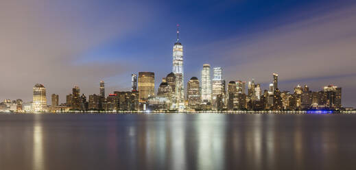 USA, New York, New York City, Lower Manhattan with One World Trade Center illuminated at dawn seen across river - AHF00078