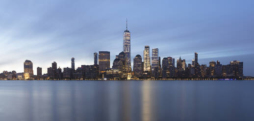 USA, New York, New York City, Lower Manhattan with One World Trade Center illuminated at dawn seen across river - AHF00079