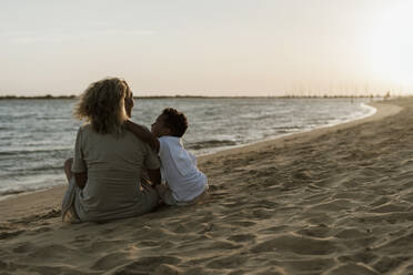 Großmutter und Enkel verbringen ihre Freizeit am Strand bei Sonnenuntergang - ERRF04354
