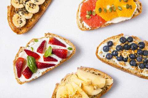 Studio shot of five slices of bread with fresh fruits stock photo