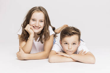 Cute siblings lying on white background - SDAHF00980