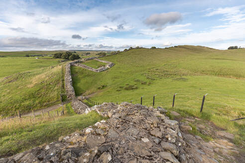 UK, England, Hexham, Hadrians Wall surrounded by green countryside hills - WPEF03395