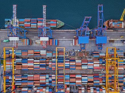 Russia, Primorsky Krai, Vladivostok, Aerial view of cargo containers in commercial dock - KNTF05387