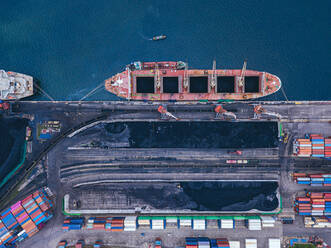 Russia, Primorsky Krai, Vladivostok, Aerial view of industrial ship moored in coal loading dock - KNTF05394