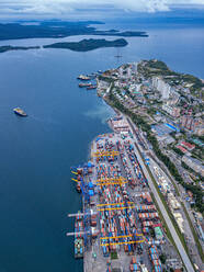Russia, Primorsky Krai, Vladivostok, Aerial view of commercial dock on shore of Sea of Japan - KNTF05398