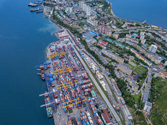 Russia, Primorsky Krai, Vladivostok, Aerial view of commercial dock on shore of Sea of Japan - KNTF05399