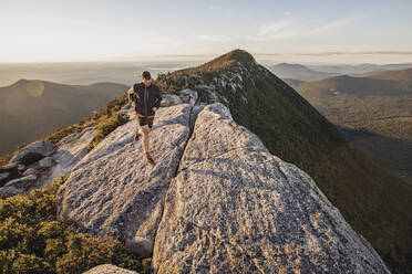 Man trail runs along summit ridge of mountain with amazing views - CAVF89240