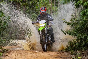 Woman riding her dirt-bike on forest track in Pak Chong / Thailand - CAVF89255