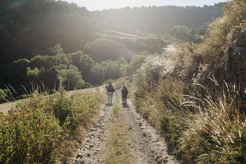 Man hiking with children on mountain stock photo