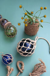 DIY maritime decorations made of crystal balls wrapped in macrame netting made of rope - GISF00646