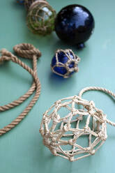 DIY maritime decorations made of crystal balls wrapped in macrame netting made of rope - GISF00647